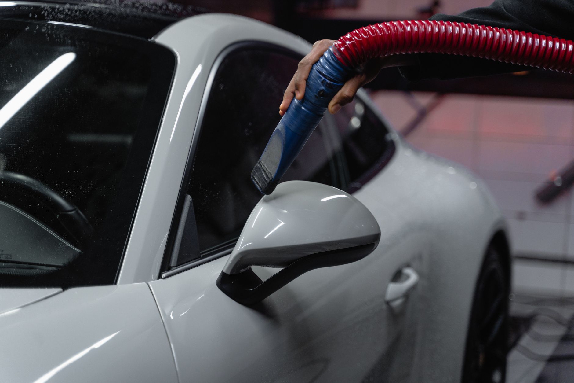 A car interior being vacuumed as part of a detailing service